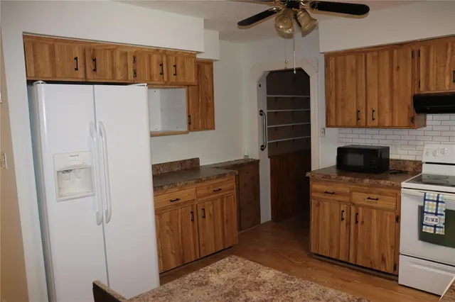 a kitchen with a refrigerator and a sink