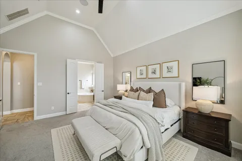 a spacious bathroom with a granite countertop double vanity sink a mirror a bathtub and window