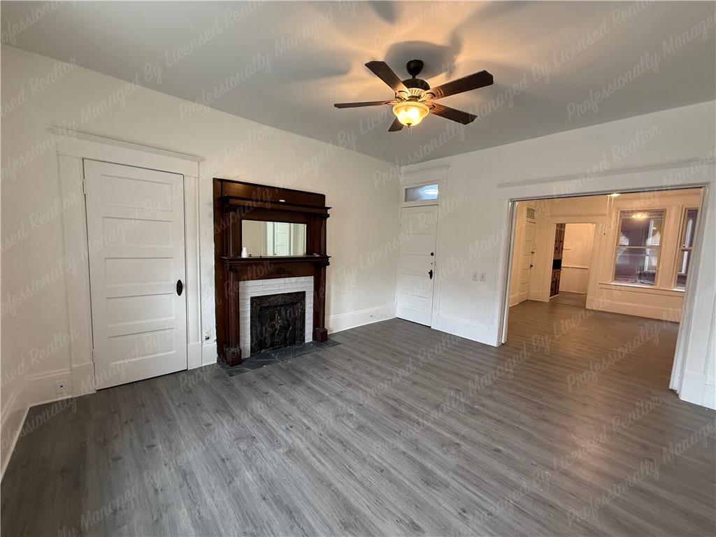 44 West High Street, Unit B Springfield, OH 45502 - Photo 8 of 31 This bright living space features elegant flooring and a charming fireplace with a detailed mantel.