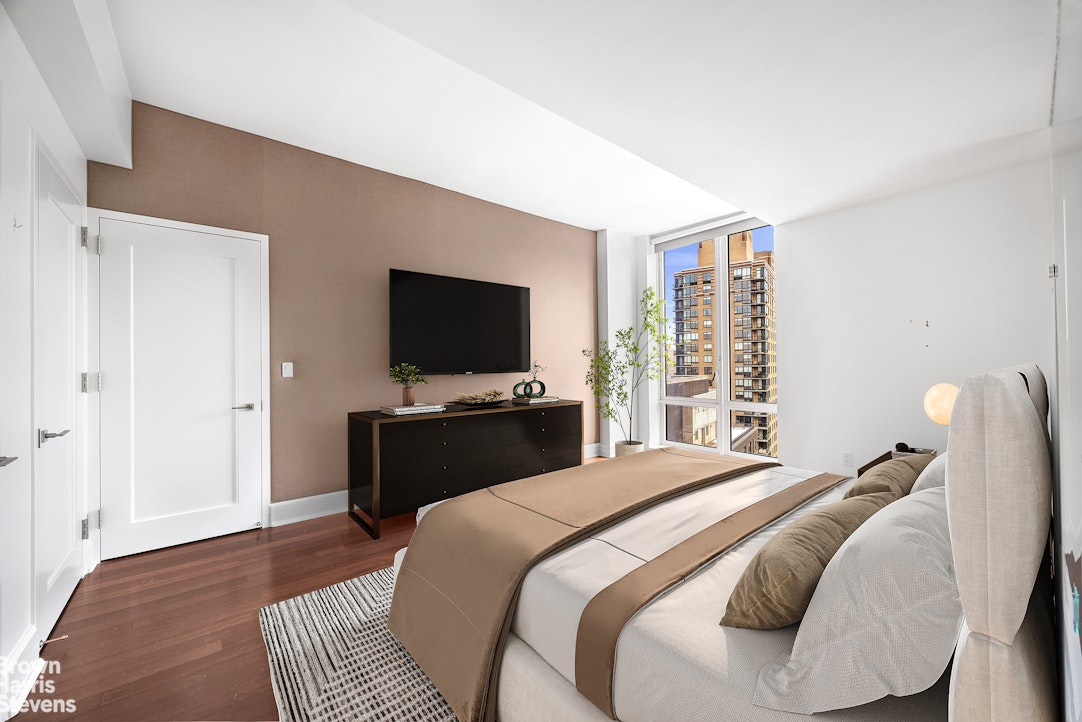 60 Riverside Boulevard, Unit 3004 Manhattan, NY 10069 - Photo 13 of 32 a bedroom with a bed and a flat screen tv