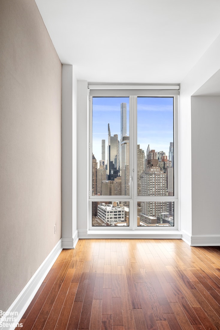 60 Riverside Boulevard, Unit 3004 Manhattan, NY 10069 - Photo 15 of 32 an empty room with wooden floor and a fireplace