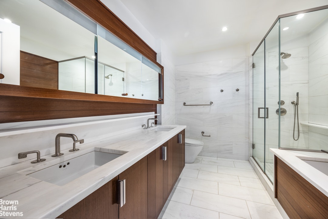 60 Riverside Boulevard, Unit 3004 Manhattan, NY 10069 - Photo 16 of 32 a bathroom with a double vanity sink mirror double and shower