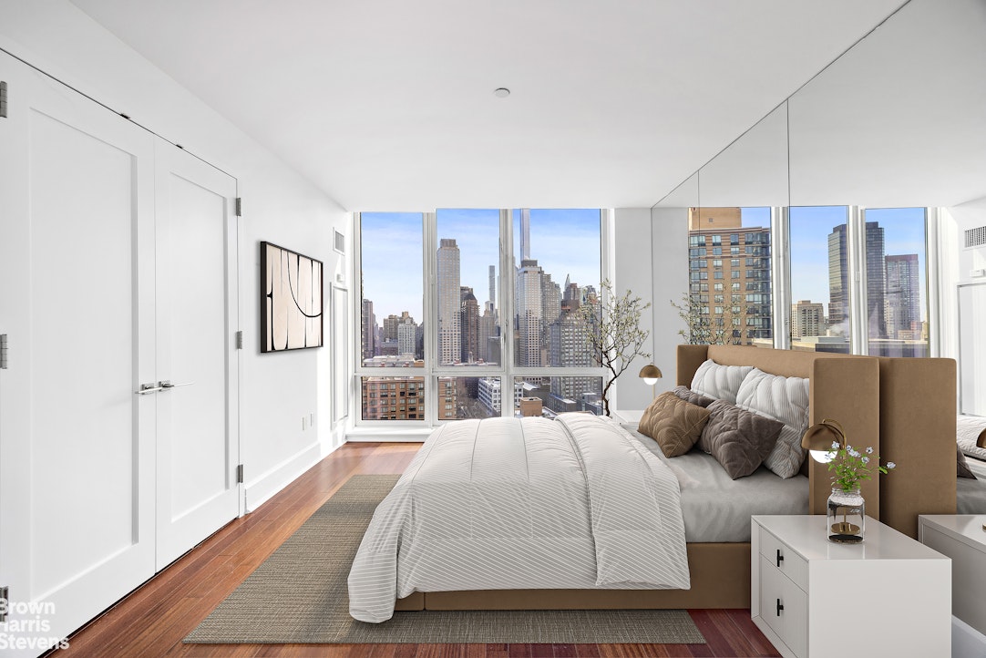 60 Riverside Boulevard, Unit 3004 Manhattan, NY 10069 - Photo 17 of 32 a bed room with two large bed and a large window