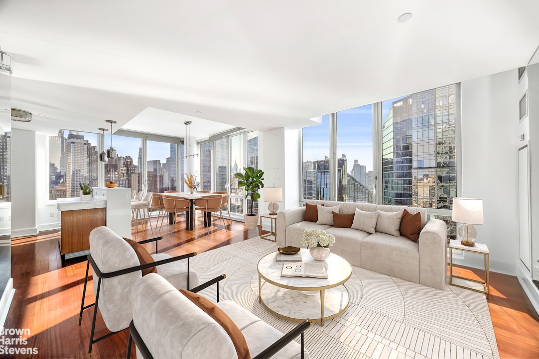 60 Riverside Boulevard, Unit 3004 Manhattan, NY 10069 - Photo 3 of 32 a living room with furniture and a large window