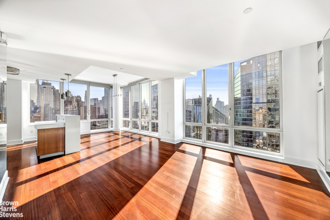 60 Riverside Boulevard, Unit 3004 Manhattan, NY 10069 - Photo 4 of 32 a spacious bedroom with a large window and a table