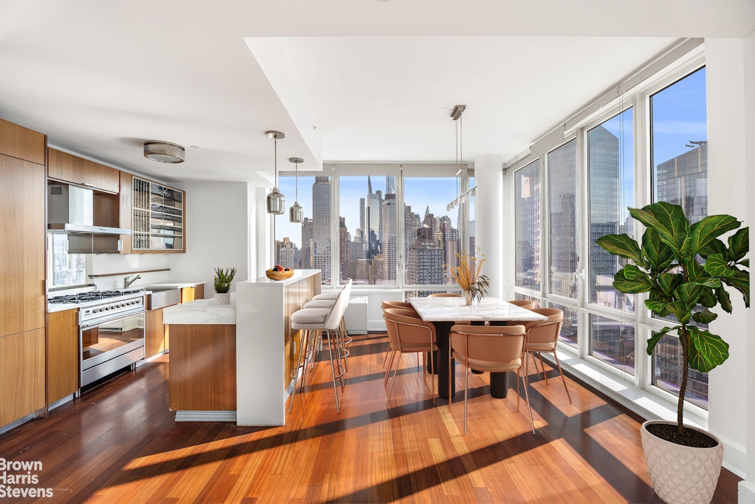 60 Riverside Boulevard, Unit 3004 Manhattan, NY 10069 - Photo 5 of 32 a living room with fireplace furniture and a large window