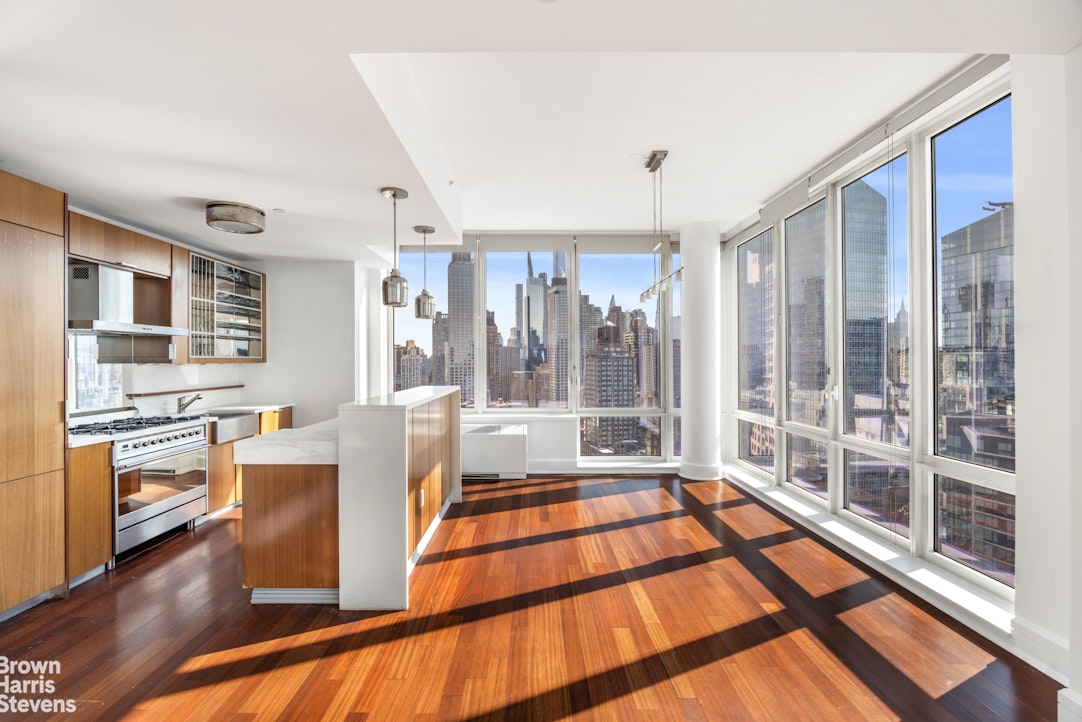 60 Riverside Boulevard, Unit 3004 Manhattan, NY 10069 - Photo 6 of 32 a living room with stainless steel appliances furniture and large windows