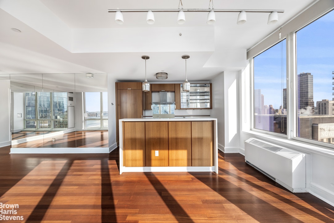 60 Riverside Boulevard, Unit 3004 Manhattan, NY 10069 - Photo 9 of 32 a view of a large room with wooden floor and windows