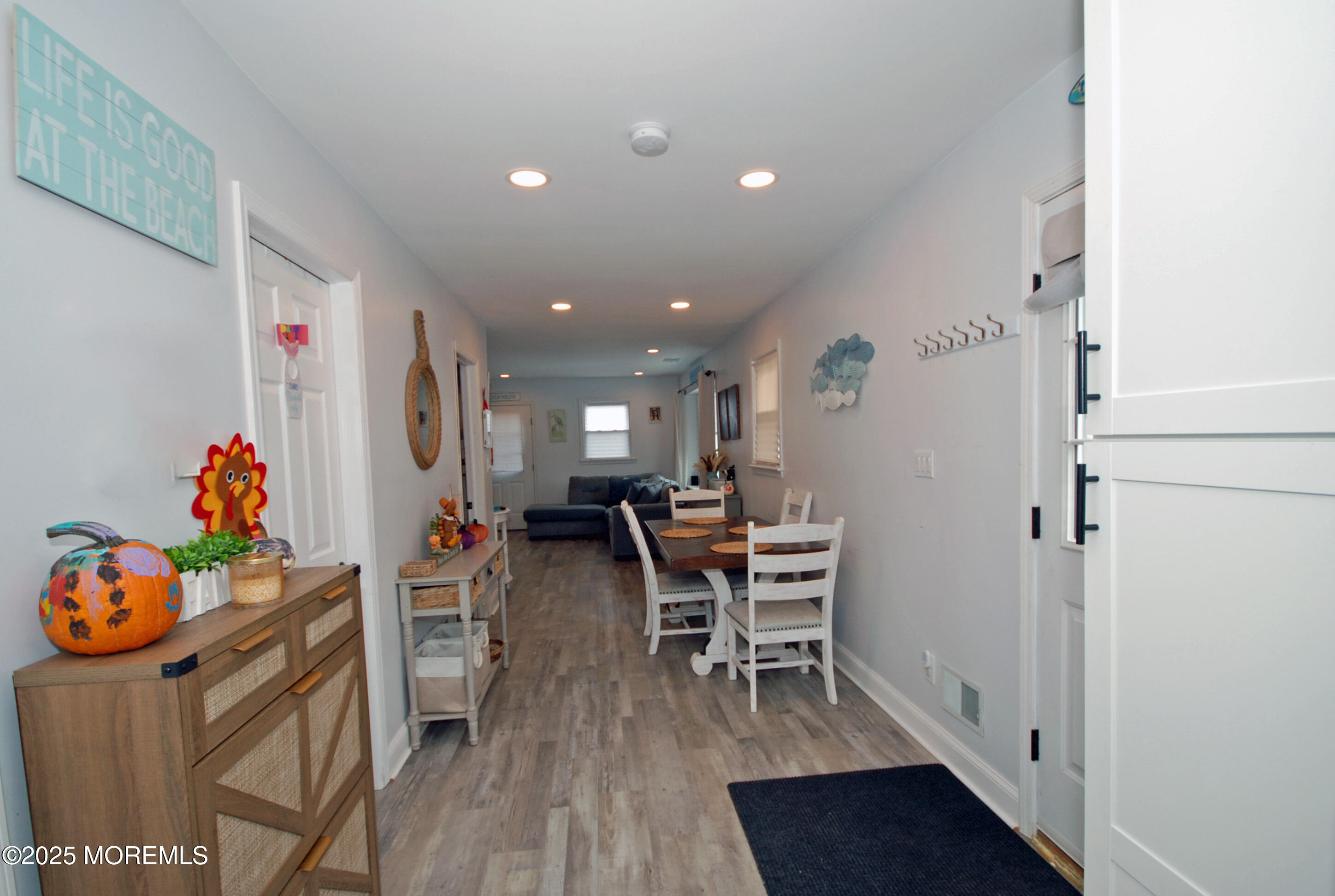 25 Beach Boulevard Highlands, NJ 07732 - Photo 11 of 32 a dining room with furniture and a wooden floor