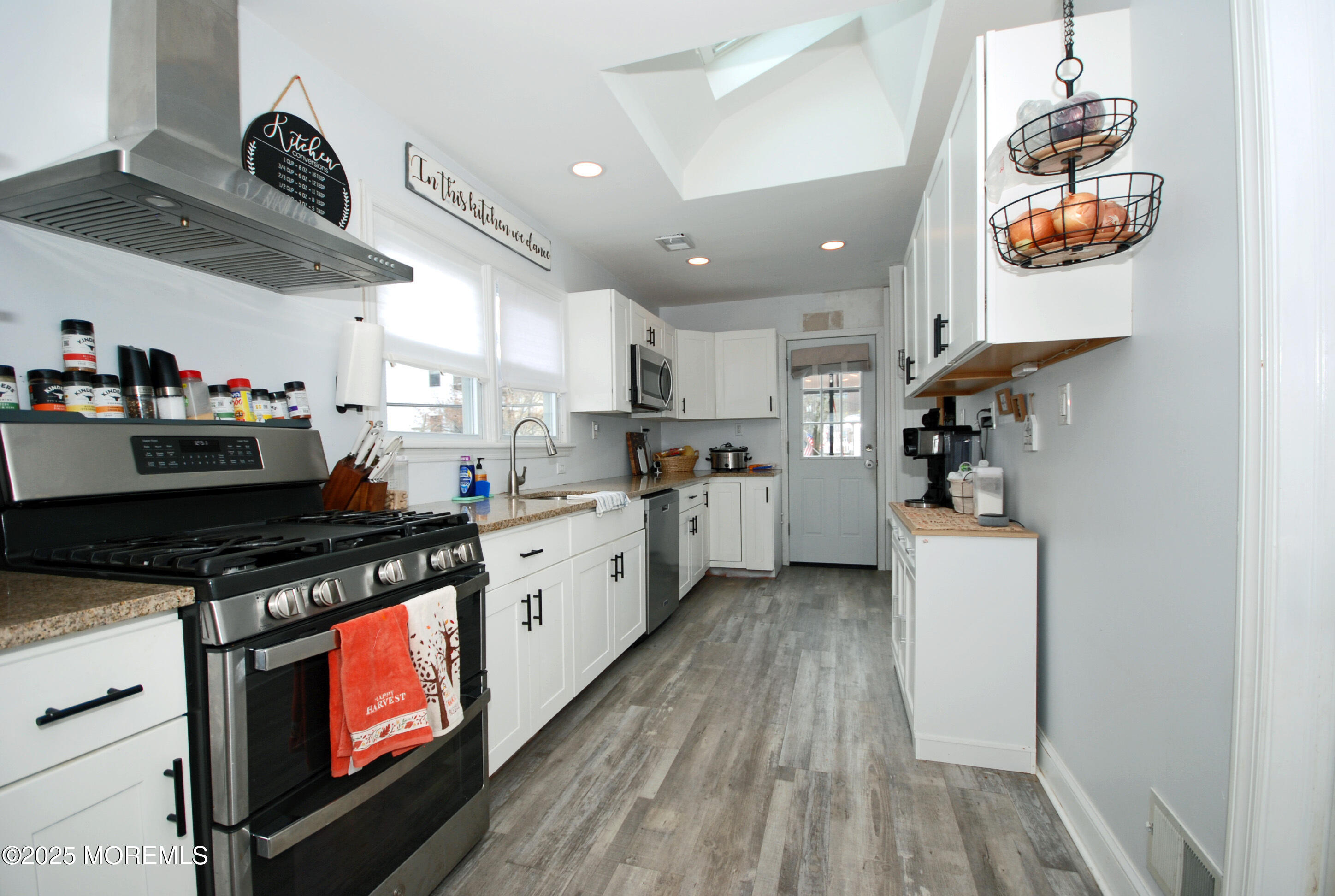 25 Beach Boulevard Highlands, NJ 07732 - Photo 12 of 32 a kitchen with stainless steel appliances granite countertop a stove a sink and a refrigerator