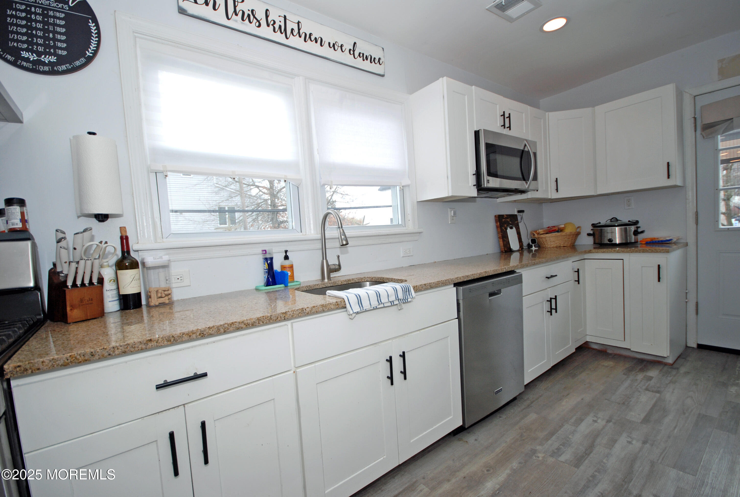 25 Beach Boulevard Highlands, NJ 07732 - Photo 13 of 32 a kitchen with stainless steel appliances white cabinets a sink and a stove