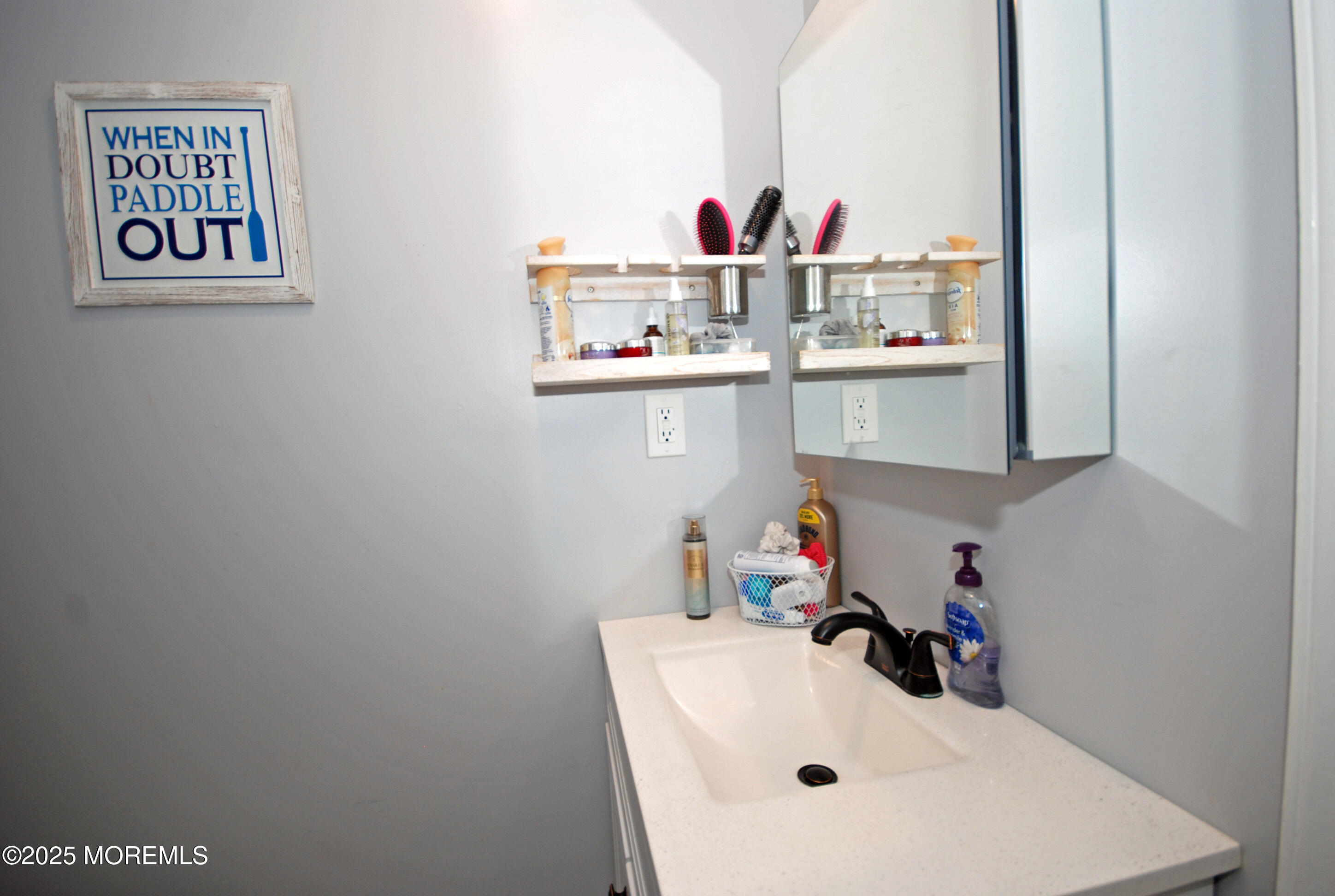 25 Beach Boulevard Highlands, NJ 07732 - Photo 19 of 32 a bathroom with a sink and a mirror