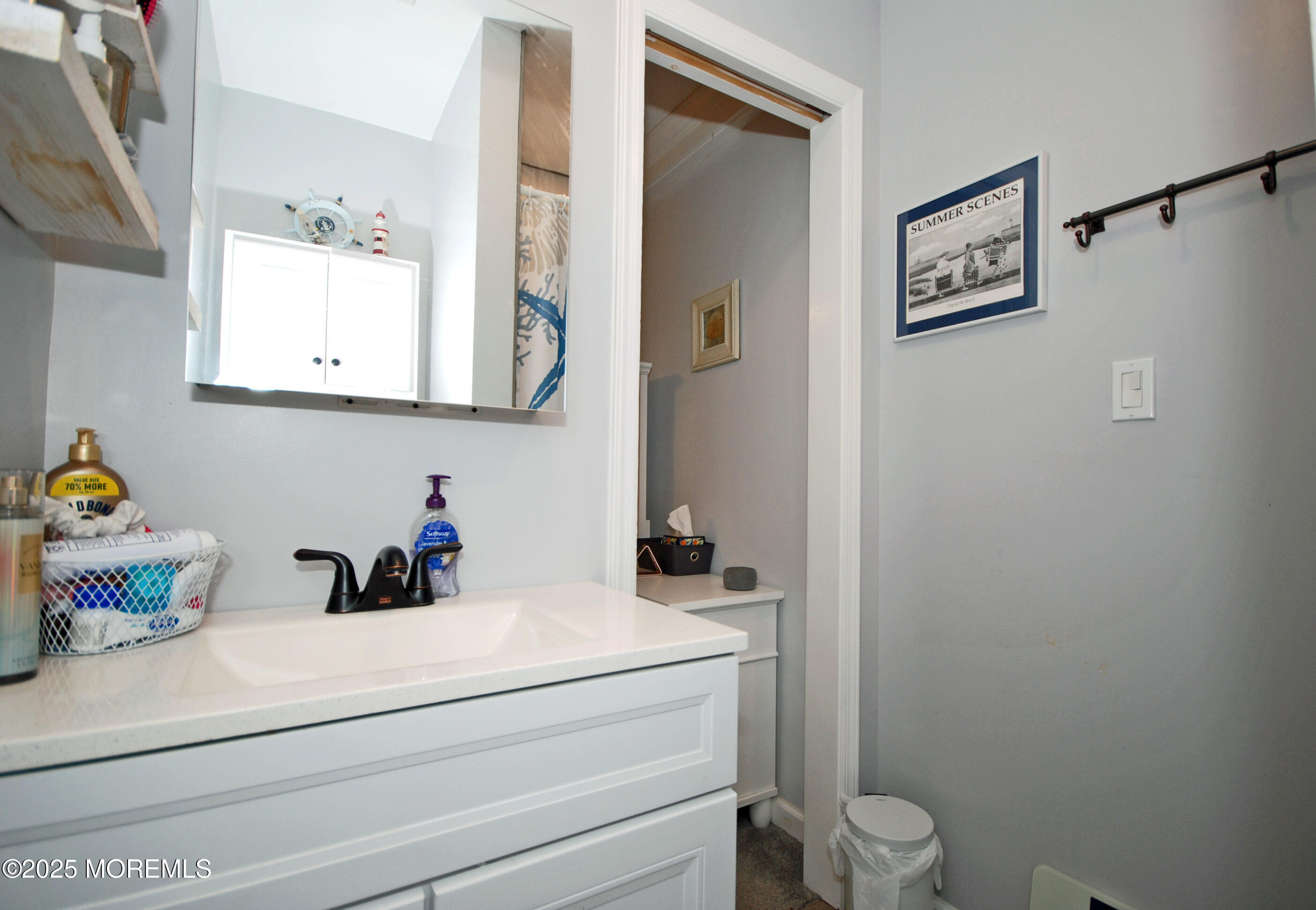 25 Beach Boulevard Highlands, NJ 07732 - Photo 20 of 32 a bathroom with a sink mirror vanity and toilet