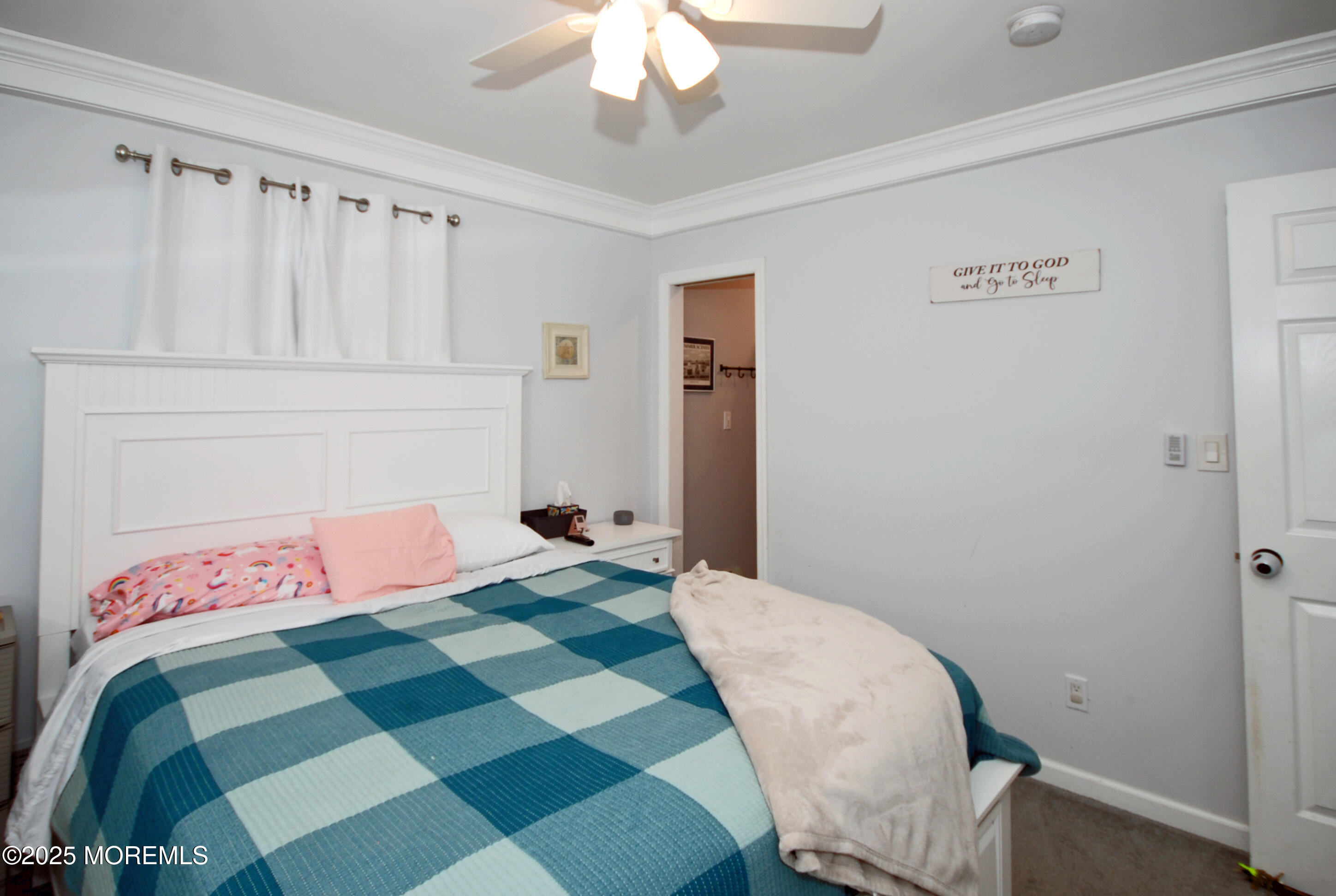 25 Beach Boulevard Highlands, NJ 07732 - Photo 23 of 32 a bedroom with a bed and a chandelier