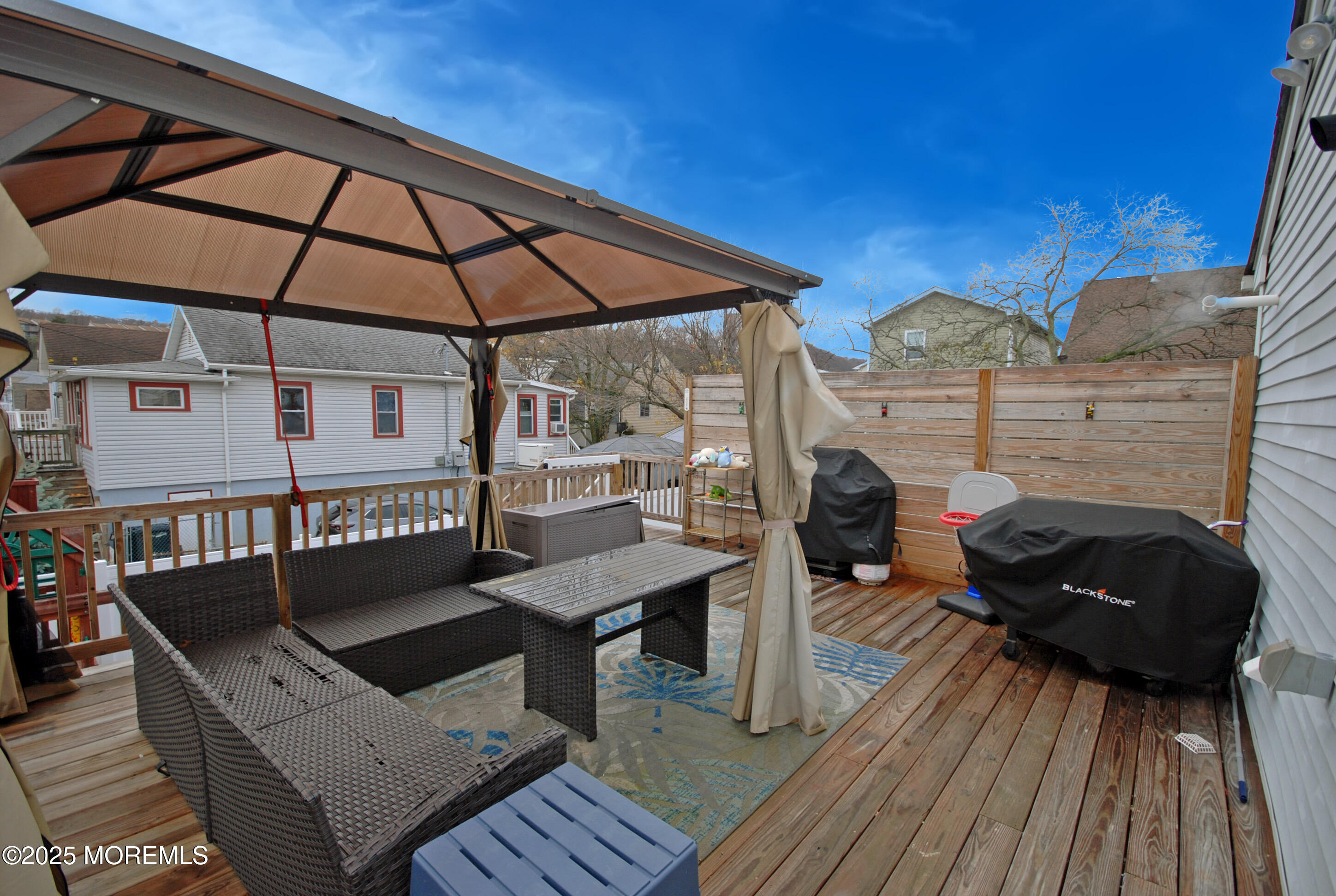 25 Beach Boulevard Highlands, NJ 07732 - Photo 29 of 32 a view of a roof deck with table and chairs with wooden floor and fence