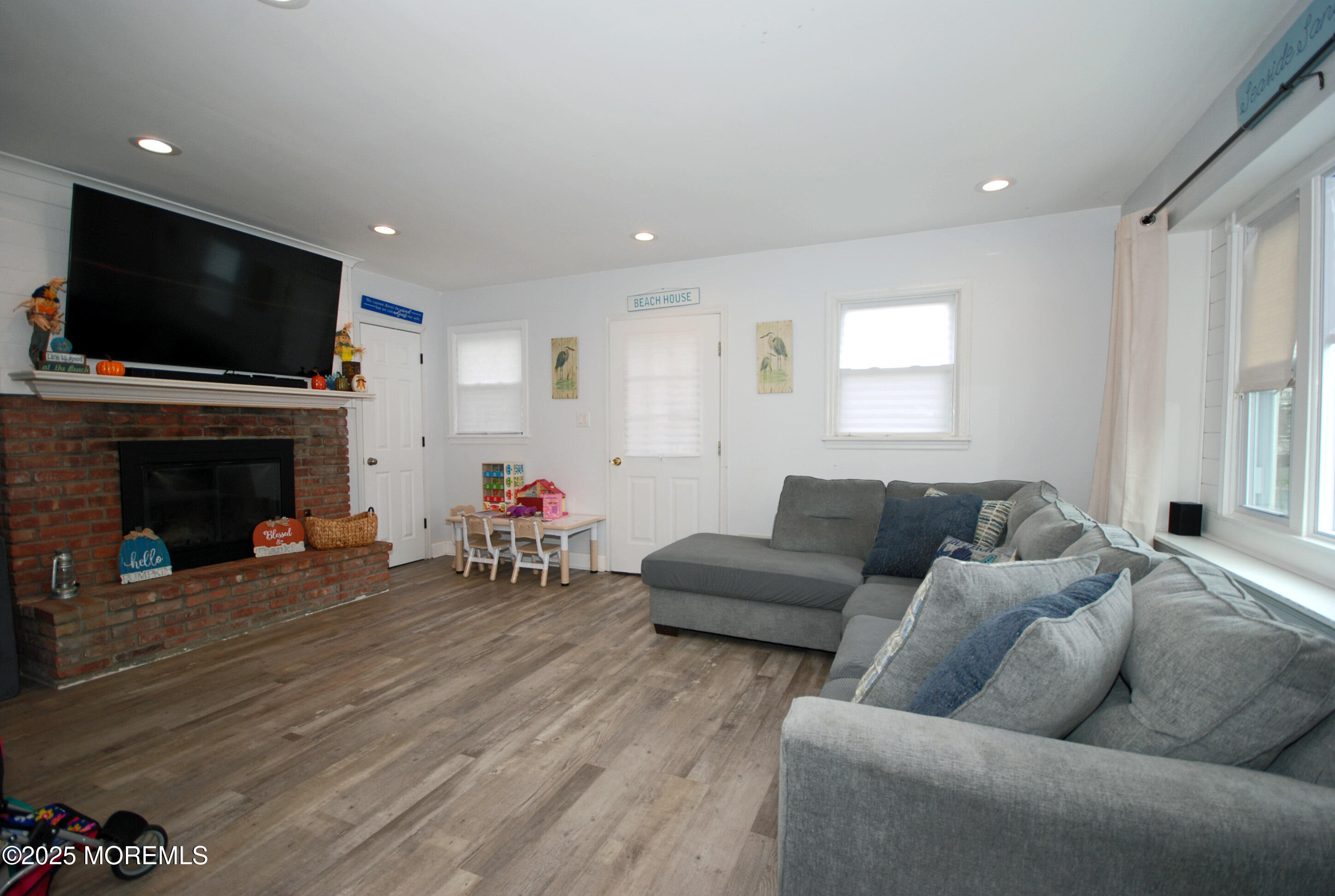 25 Beach Boulevard Highlands, NJ 07732 - Photo 6 of 32 a living room with furniture and a flat screen tv