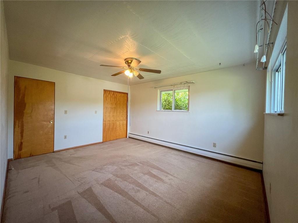 115 Grohman Road Butler, PA 16002 - Photo 19 of 39 an empty room with a chandelier fan and windows