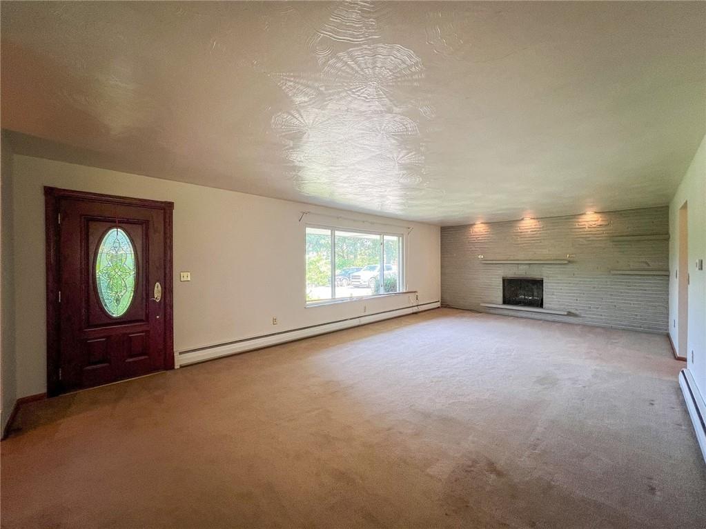 115 Grohman Road Butler, PA 16002 - Photo 3 of 39 an empty room with windows and fireplace