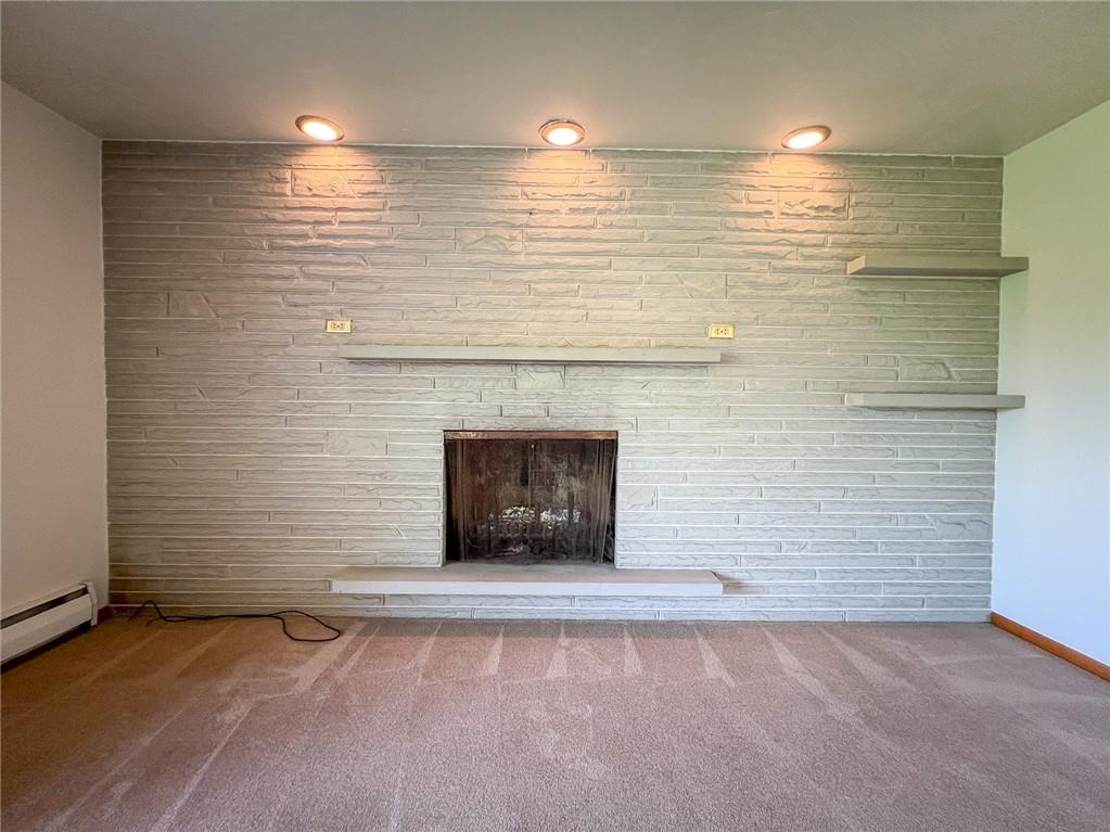 115 Grohman Road Butler, PA 16002 - Photo 5 of 39 a view of an empty room with a fireplace