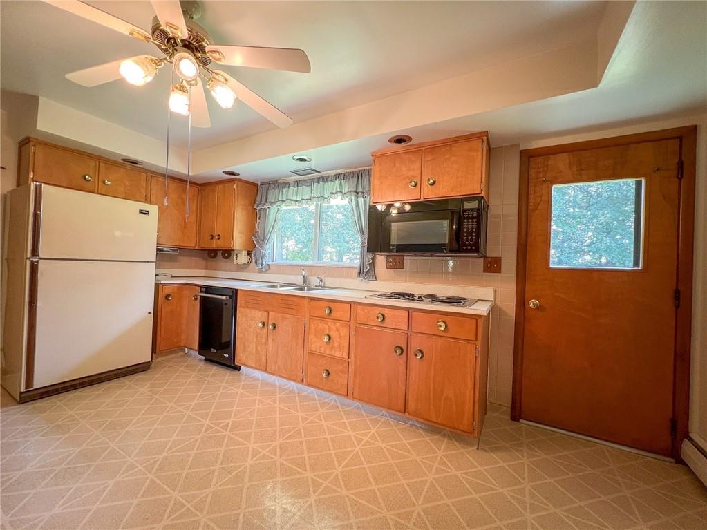 115 Grohman Road Butler, PA 16002 - Photo 10 of 39 a kitchen with stainless steel appliances granite countertop a refrigerator a sink dishwasher a stove with a dining table and chairs