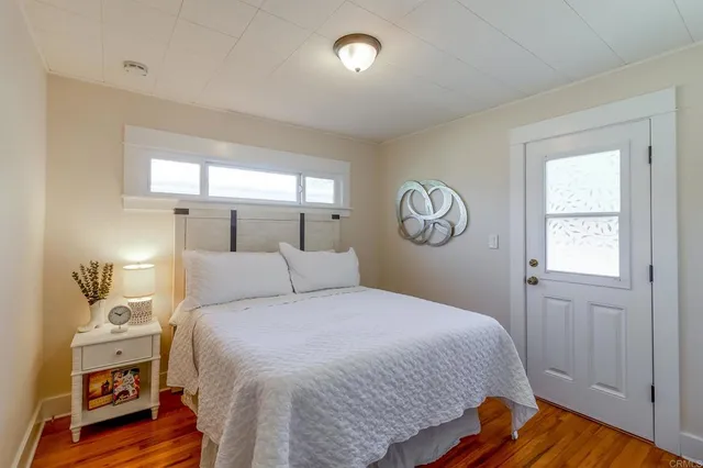 a bedroom with a bed and a window