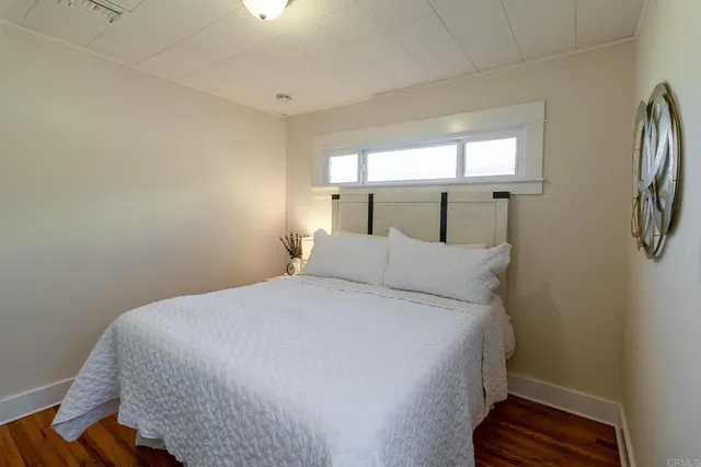 a bedroom with a dresser and a mirror