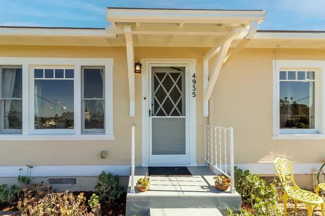 a living room with furniture a wooden floor and a potted plant