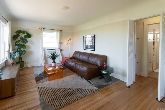 a bedroom with furniture and wooden floor