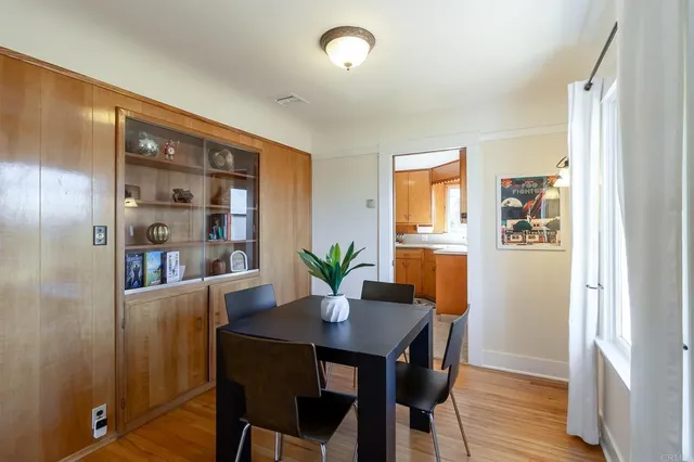 a view of a dining room with furniture and a potted plant