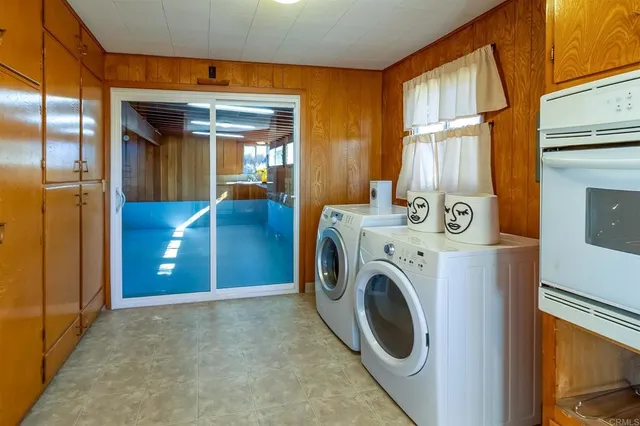 a utility room with sink dryer and washer