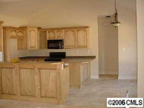 4163 Fletcher Funderburk Road Lancaster, SC 29720 - Photo 6 of 8 a kitchen with stainless steel appliances a refrigerator and a stove
