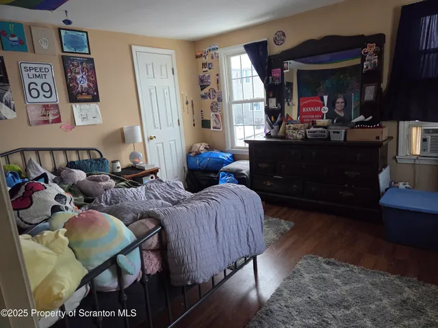 a bedroom with furniture and a window