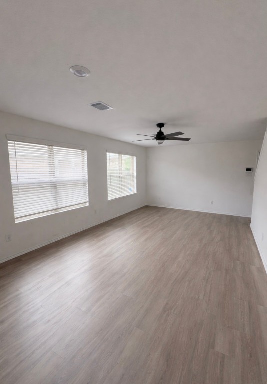 101 Cullen Street Angleton, TX 77515 - Photo 3 of 6 Spacious, well-lit room living room with light wood laminate flooring and large windows.