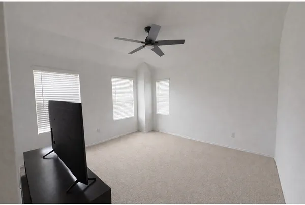 a view of room with window and ceiling fan