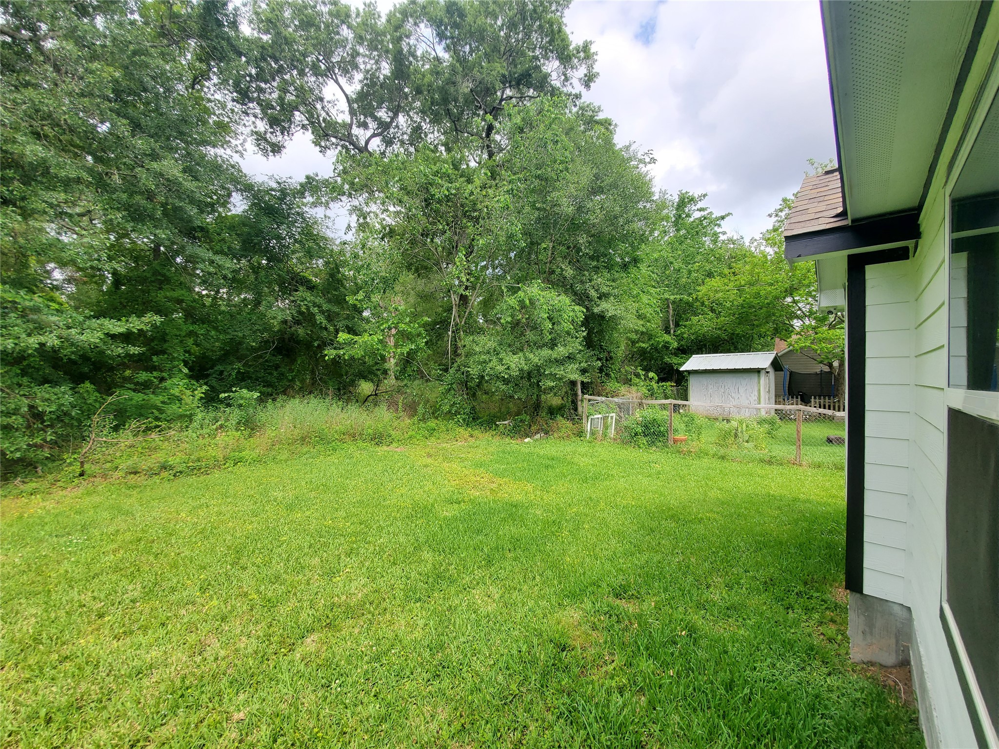 1306 North 9th Street Conroe, TX 77301 - Photo 47 of 47 a view of a backyard with a garden