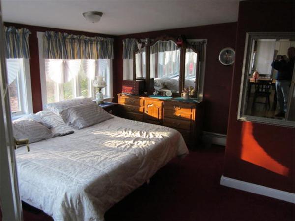541 Hatherly Road Scituate, MA 02066 - Photo 8 of 11 a bedroom with a bed and wooden floor