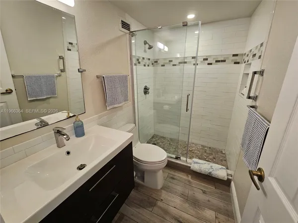 a bathroom with a sink toilet and shower