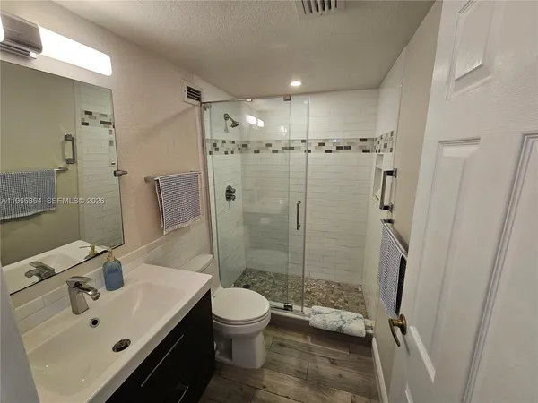 a bathroom with a sink toilet and shower