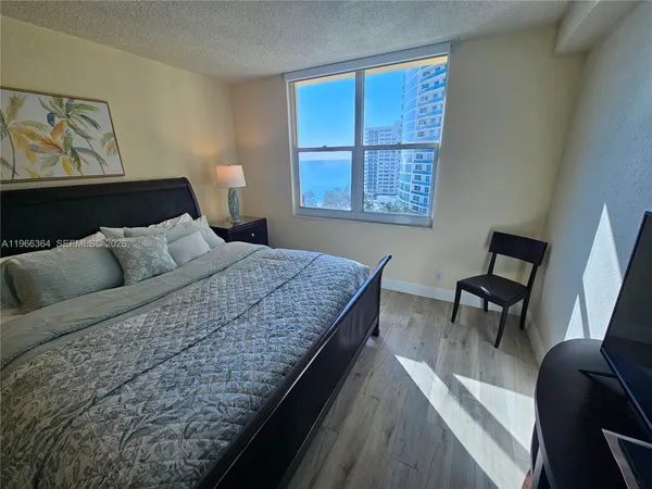 a bedroom with bed and window