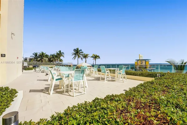 a view of swimming pool with outdoor seating and plants