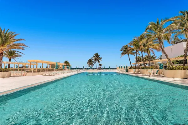 a swimming pool with outdoor seating and garden