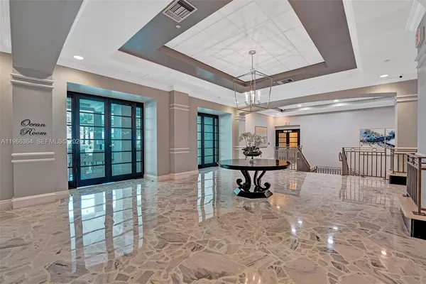 a view of a hallway with workspace and windows