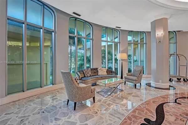 a living room with furniture and a large window