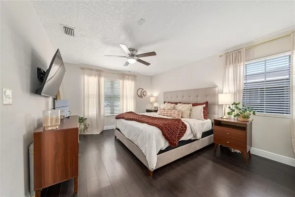 a bed room with a bed window and a television