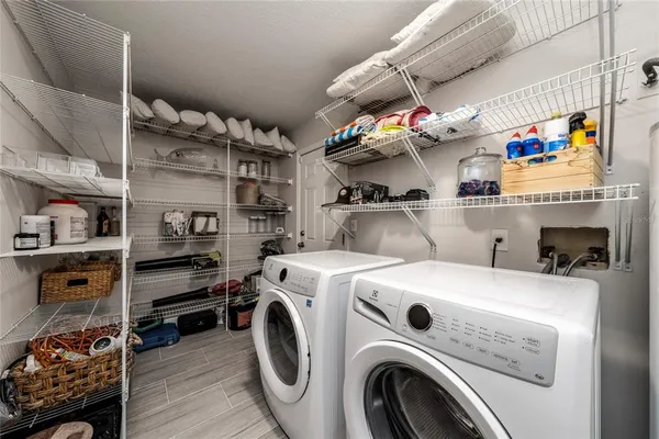 a view of storage and utility room with washer and dryer