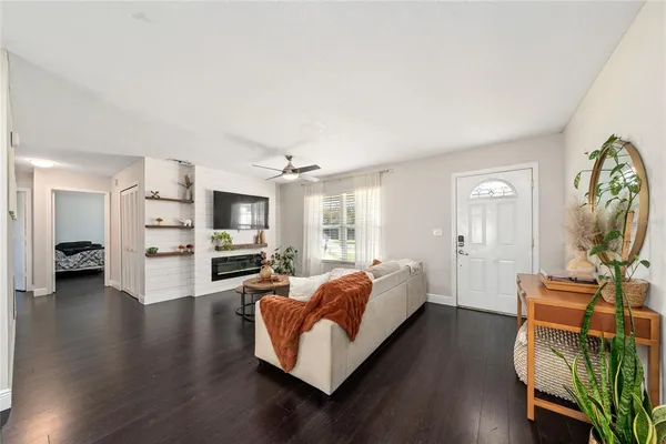 a spacious bedroom with a bed and wooden floor