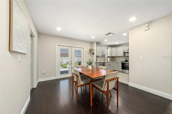 a dining room with furniture and wooden floor
