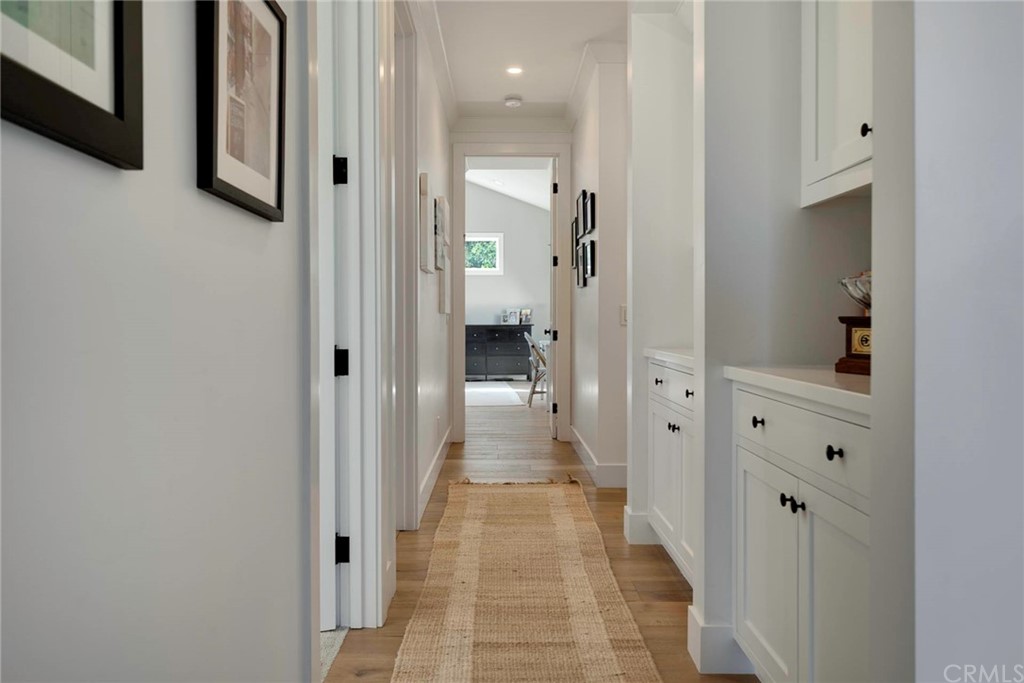 277 Knox Place Costa Mesa, CA 92627 - Photo 15 of 21 a view of a hallway with wooden shelves