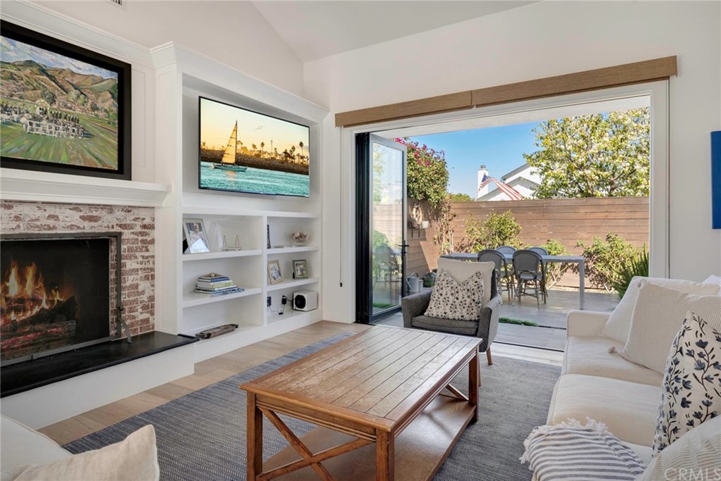 277 Knox Place Costa Mesa, CA 92627 - Photo 2 of 21 a living room with furniture and a fireplace