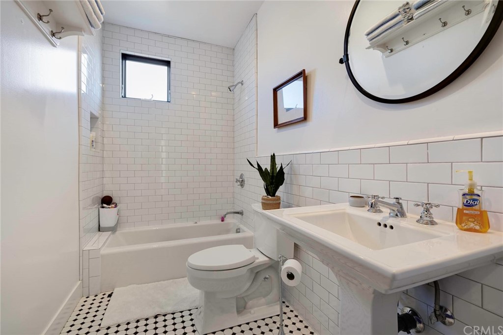 277 Knox Place Costa Mesa, CA 92627 - Photo 21 of 21 a bathroom with a sink a toilet and a mirror